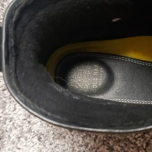 Black leather Cole Haan combat boots.